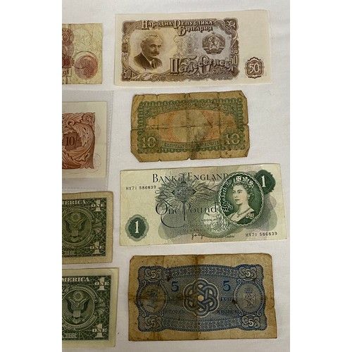 557 - Two ten shilling notes, a one pound note, two U.S. one dollar bills, a 1951 Bulgarian 50 Leva note, ... 