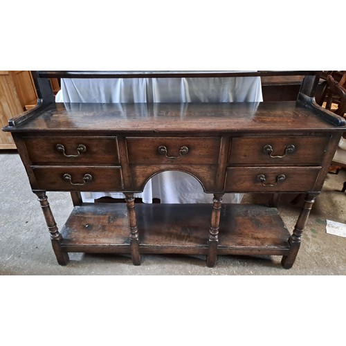 64 - An 18thC oak dresser with rack to back. 193cm x 138cm x 43cm.