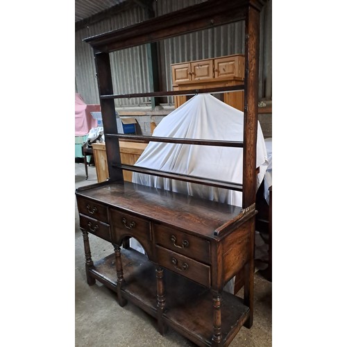 64 - An 18thC oak dresser with rack to back. 193cm x 138cm x 43cm.