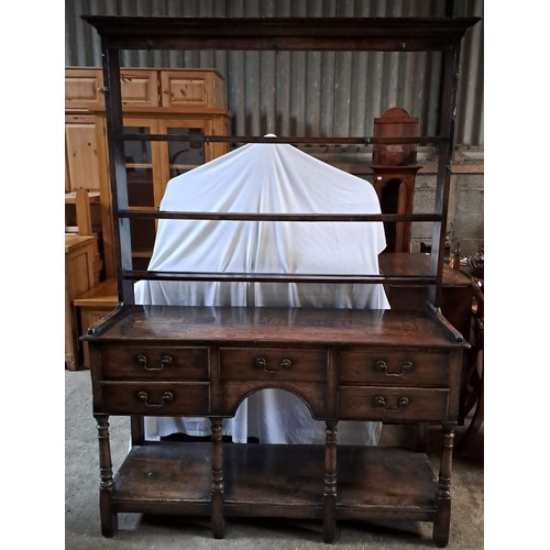 64 - An 18thC oak dresser with rack to back. 193cm x 138cm x 43cm.