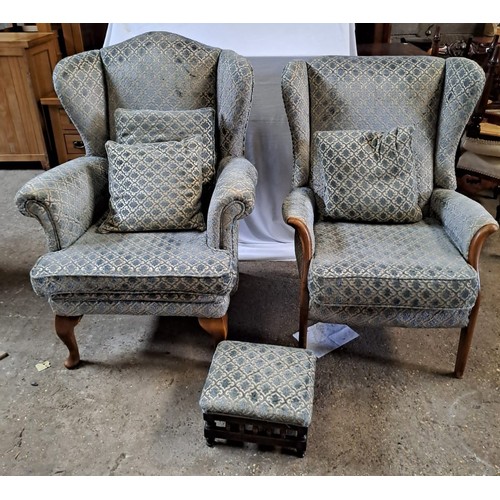 66 - Two blue wingback chairs and footstool. Height to seat 44cm h.