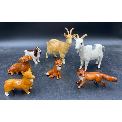 133 - A collection of Beswick animals to include two foxes (one sitting), three dogs spaniel, dachshund, c... 