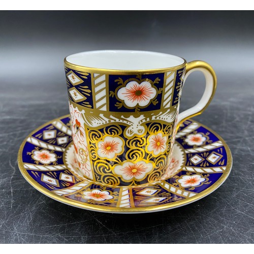 137 - Royal Crown Derby to include coffee can and saucer 2451 and plate 1128, 27cm d.