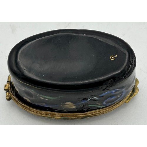 986 - Continental enamel and gilt metal patch box. 6 x 3.5cm.