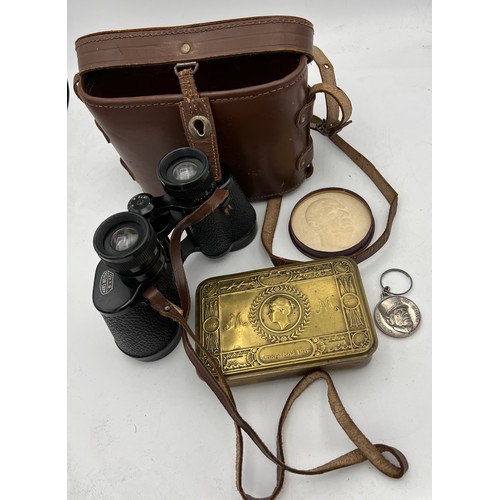 989 - A WWI brass Christmas tin 1914 13cm w, together with Hans Weiss binoculars in leather case,  Charles... 