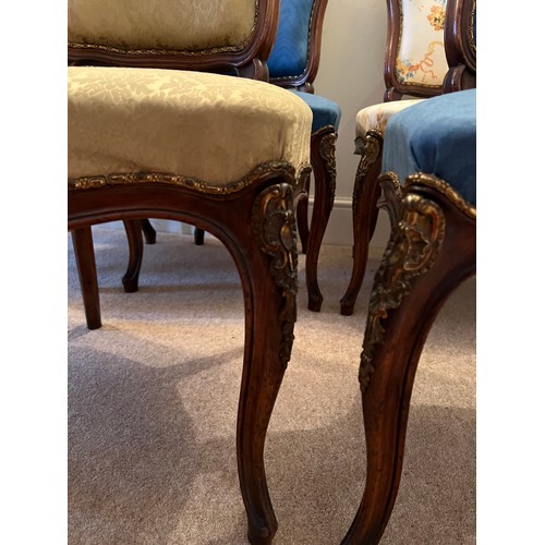 72 - Seven French mahogany and ormolu mounted cabriole legged salon chairs. Upholstered variously, togeth... 