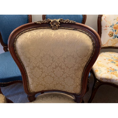 72 - Seven French mahogany and ormolu mounted cabriole legged salon chairs. Upholstered variously, togeth... 