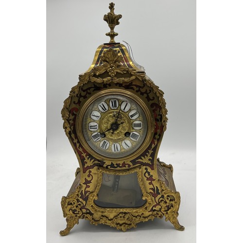 830 - A 19thC French Buhl red tortoiseshell two train mantle clock striking on a gong. 38cm h.