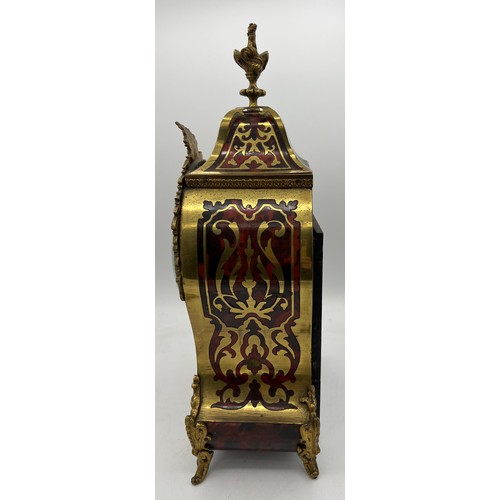 830 - A 19thC French Buhl red tortoiseshell two train mantle clock striking on a gong. 38cm h.