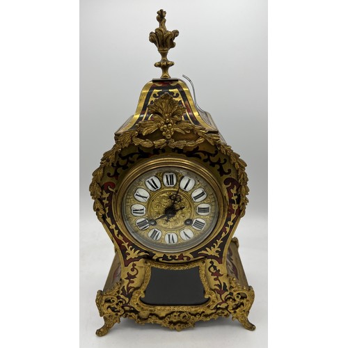 830 - A 19thC French Buhl red tortoiseshell two train mantle clock striking on a gong. 38cm h.