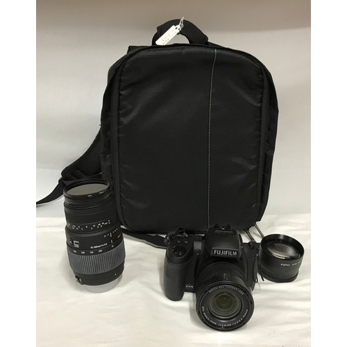 885 - A camera bag and accessories to include a Fujifilm Finepix HS 30 EXR camera, Sigma DG 70-300mm lens,... 