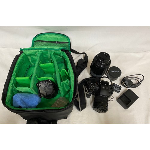 885 - A camera bag and accessories to include a Fujifilm Finepix HS 30 EXR camera, Sigma DG 70-300mm lens,... 