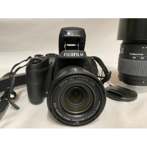 885 - A camera bag and accessories to include a Fujifilm Finepix HS 30 EXR camera, Sigma DG 70-300mm lens,... 