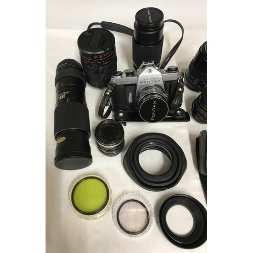 888 - A camera bag and accessories to include an Asahi Pentax SP Spotmatic camera, a mirror lens 500mm, Op... 