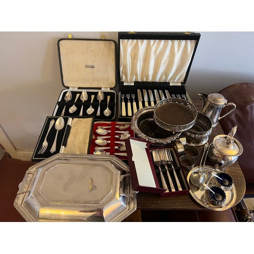 679 - A quantity of silver plated cutlery etc to include boxed spoons, lidded tureen, bottle stands and na... 