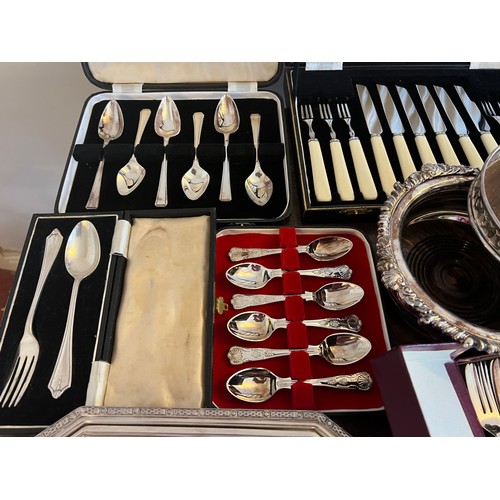 679 - A quantity of silver plated cutlery etc to include boxed spoons, lidded tureen, bottle stands and na... 