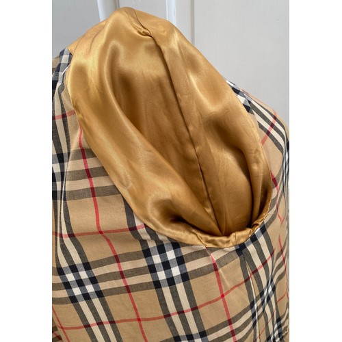 878 - Burberry - A gents khaki single breasted rain mac with tartan lining. Approx armpit to armpit 64cm/2... 