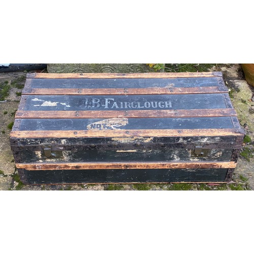 962 - An early 20thC wood and metal bound steamer trunk belonging to J.B.Fairclough, with carry handle to ... 