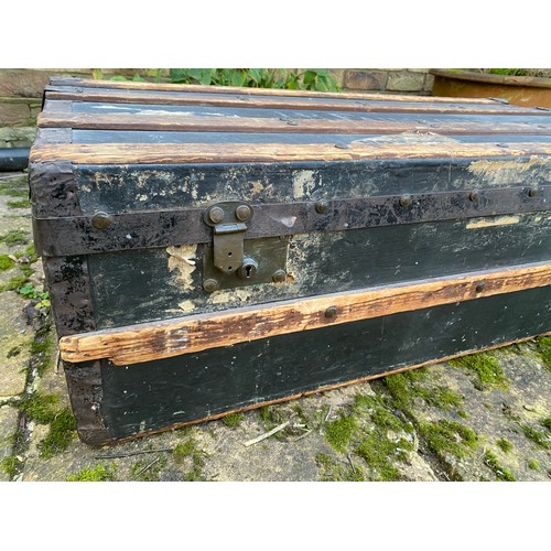 962 - An early 20thC wood and metal bound steamer trunk belonging to J.B.Fairclough, with carry handle to ... 