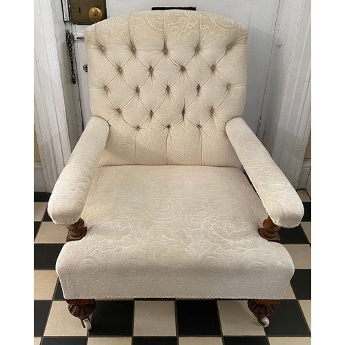 62 - A late 19thC button back chair with oak legs and supports and ceramic castors.