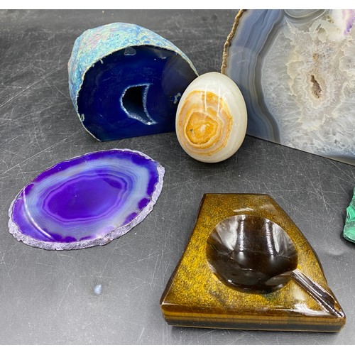 965 - A collection of four dyed agate geodes, varying sizes along with an onyx egg and a stone ashtray.