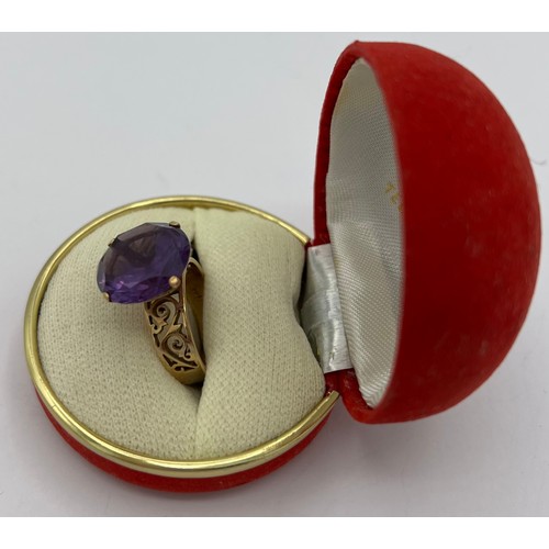 486 - A yellow metal ring marked 14K set with purple stone. Size O. Weight 6.1gm.