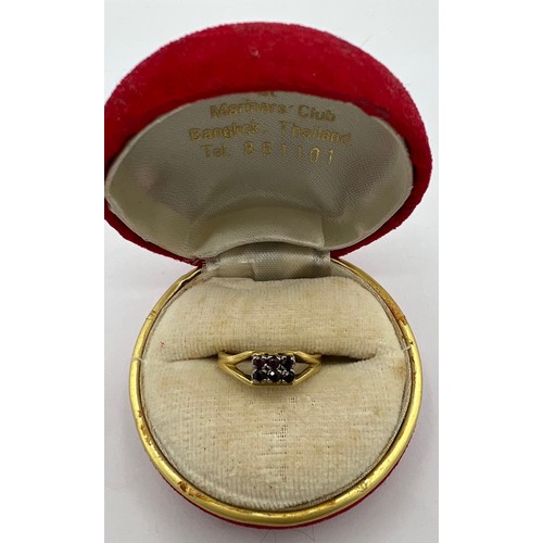 487 - An 18 carat gold ring set with six red stones. Size J. Weight 2.7gm.