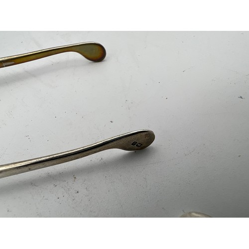 768 - A quantity of hallmarked silver to include wishbone, Birmingham 1949 James Swan & Son, Strainer, She... 