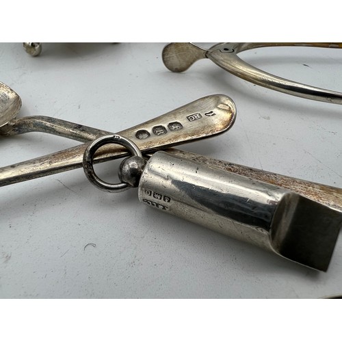 768 - A quantity of hallmarked silver to include wishbone, Birmingham 1949 James Swan & Son, Strainer, She... 