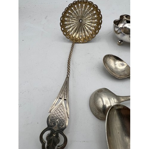 768 - A quantity of hallmarked silver to include wishbone, Birmingham 1949 James Swan & Son, Strainer, She... 