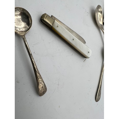 768 - A quantity of hallmarked silver to include wishbone, Birmingham 1949 James Swan & Son, Strainer, She... 