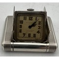 An Art Deco Dunhill silver miniature travel clock, engine turned case with hinged divided doors encl... 