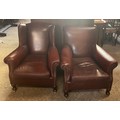 A pair of Edwardian 1904 hide leather upholstered easy chairs with turned front legs and castors. 90... 
