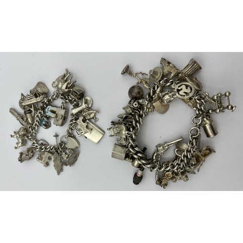 499 - Two hallmarked silver charm bracelets both with a multitude of charms, mainly silver. 247gm total we... 