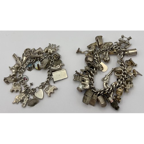 499 - Two hallmarked silver charm bracelets both with a multitude of charms, mainly silver. 247gm total we... 