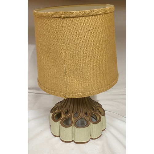 913 - A table lamp with ornate fretwork ceramic base which shines to both top and bottom. Height approx 47... 