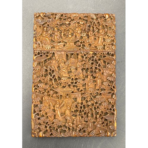 919 - A Chinese sandalwood card case, heavily carved with figures amongst pagodas and foliage, 11.5cm x 7.... 