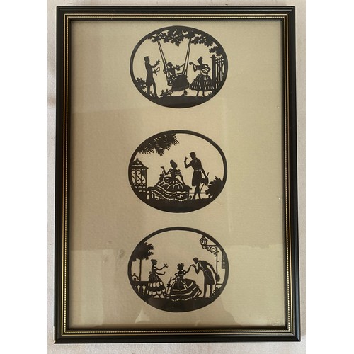 1129 - A small framed picture of three silhouettes 32cm x 23cm.