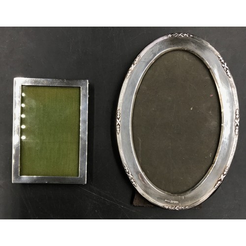 775 - Two silver mounted picture frames, oval one 1916 J&R Griffin 16cm x 11cm, square one Birmingham 1922... 