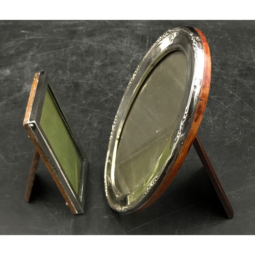 775 - Two silver mounted picture frames, oval one 1916 J&R Griffin 16cm x 11cm, square one Birmingham 1922... 