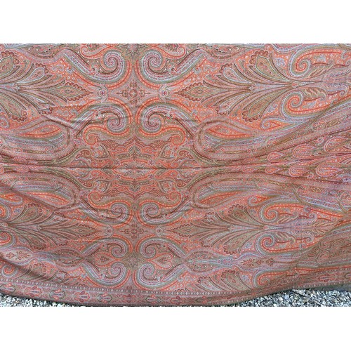 881 - A 19thC paisley patterned crinoline shawl. 335cm l x164cm w.