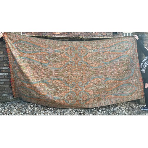 881 - A 19thC paisley patterned crinoline shawl. 335cm l x164cm w.