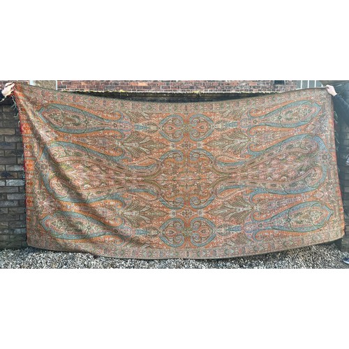 881 - A 19thC paisley patterned crinoline shawl. 335cm l x164cm w.