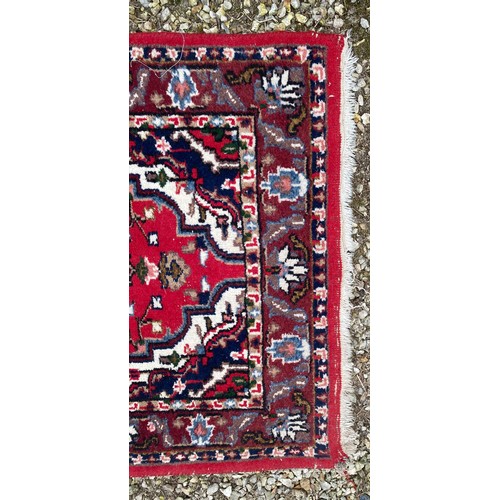 958 - A Persian rug measuring 165cm x 92cm.