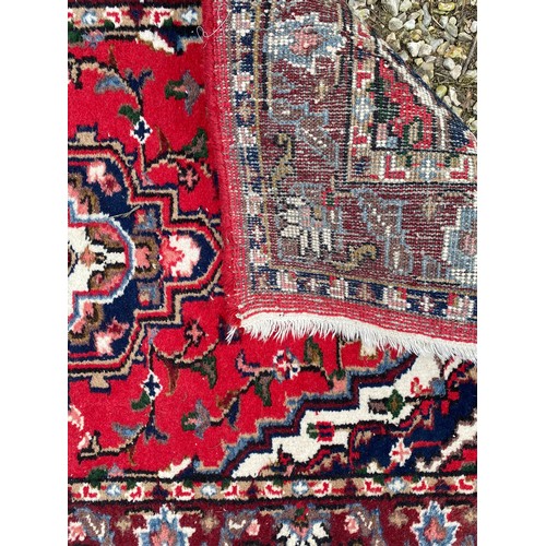 958 - A Persian rug measuring 165cm x 92cm.