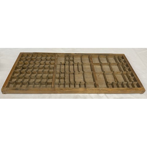 971 - A Wooden tray compartmentalised to take Printers' lettering 83cm x 37cm.