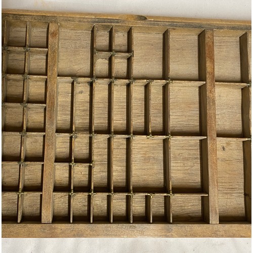 971 - A Wooden tray compartmentalised to take Printers' lettering 83cm x 37cm.