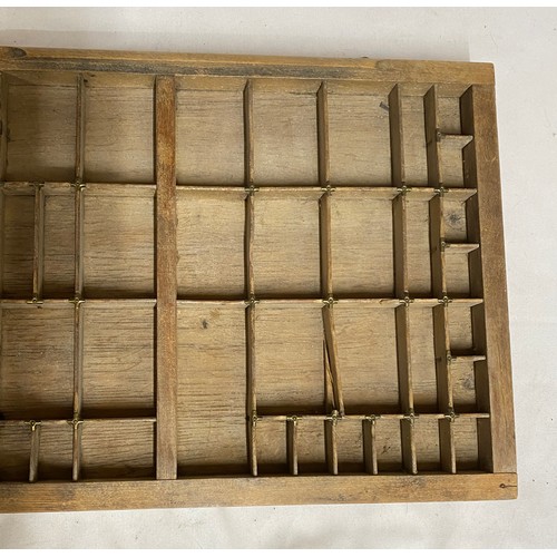 971 - A Wooden tray compartmentalised to take Printers' lettering 83cm x 37cm.