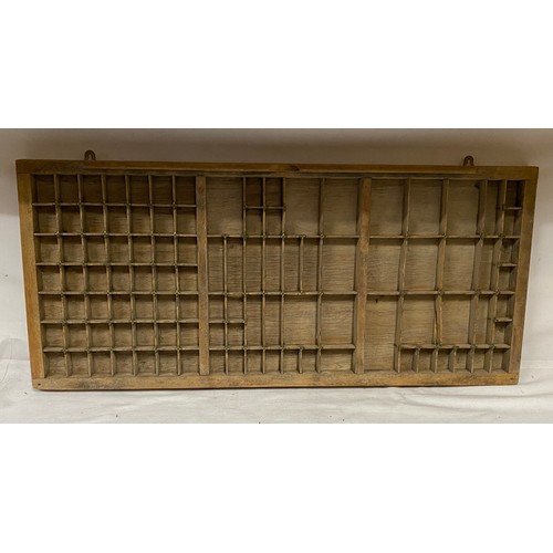 971 - A Wooden tray compartmentalised to take Printers' lettering 83cm x 37cm.