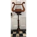 An Edwardian mahogany adjustable music stand. The lyre shaped music support on an extending support ... 